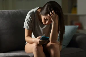 teen girl on phone struggling with debts